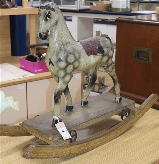 A rare Victorian carved and painted wood dapple grey rocking horse, W.31in. H.22in.